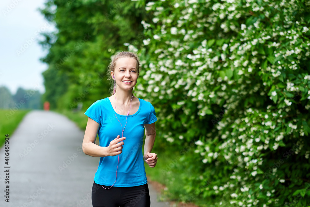 Running woman atletic spotsman training in the summer park. Outdoor fitness portrait Running woman atletic spotsman training in the summer park. Outdoor fitness portrait