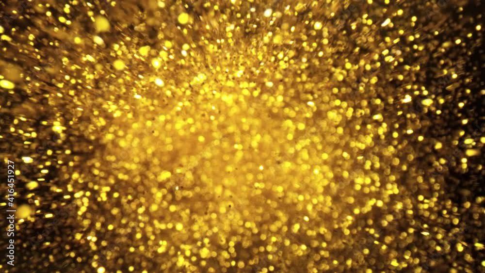 Super slow motion of glittering golden particles on black background. Filmed on high speed cinema camera, 1000 fps. Super slow motion of glittering golden particles on black background. Filmed on high speed cinema camera, 1000 fps.
