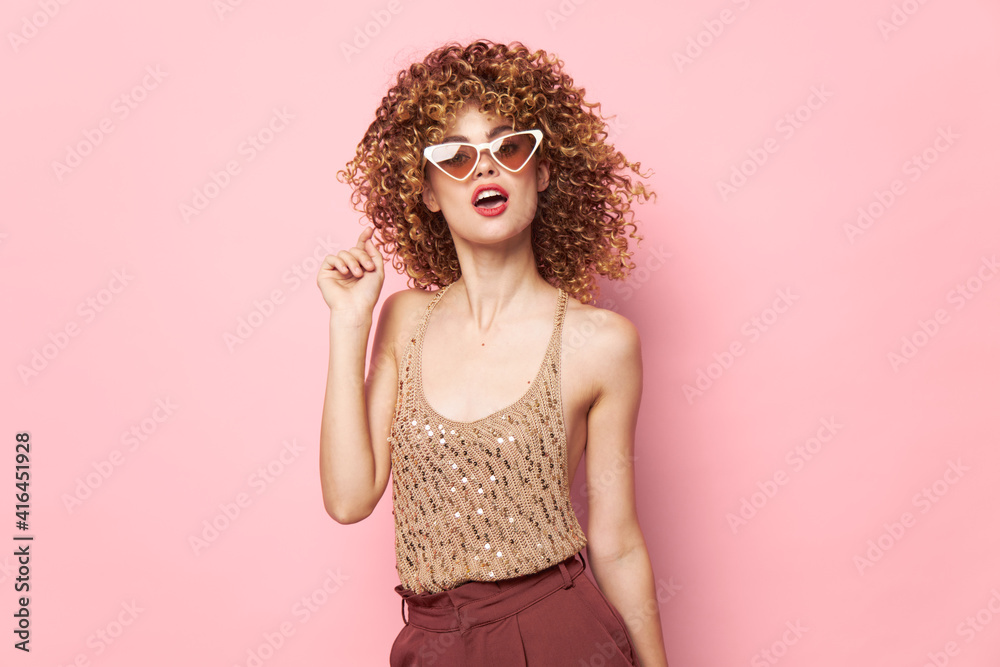 Pretty woman Lips dark glasses curly hair studio pink background Pretty woman Lips dark glasses curly hair studio pink background