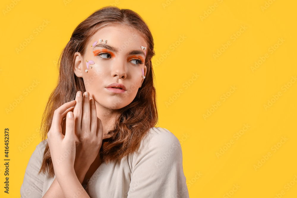 Portrait of beautiful young woman with creative makeup on color background Portrait of beautiful young woman with creative makeup on color background
