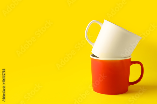 Empty cups on color background