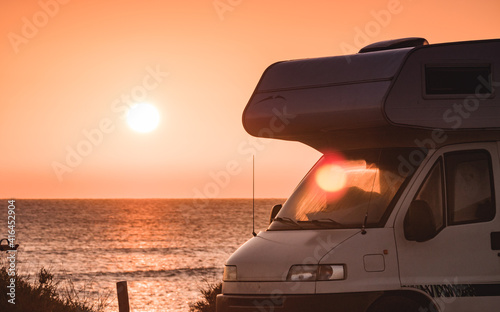 Camper vehicle on beach at sunrise © Voyagerix