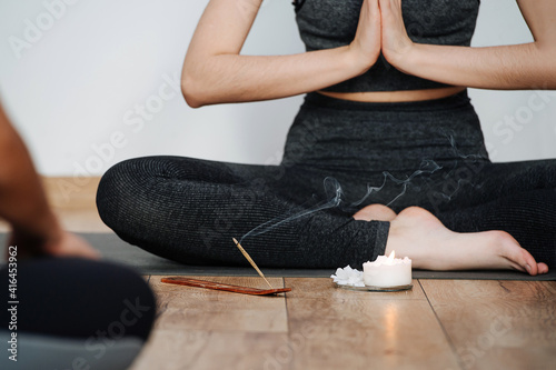 Quadro em tela Cropped image of female instructor practicing yoga, sitting on a floor with legs closely tucked
