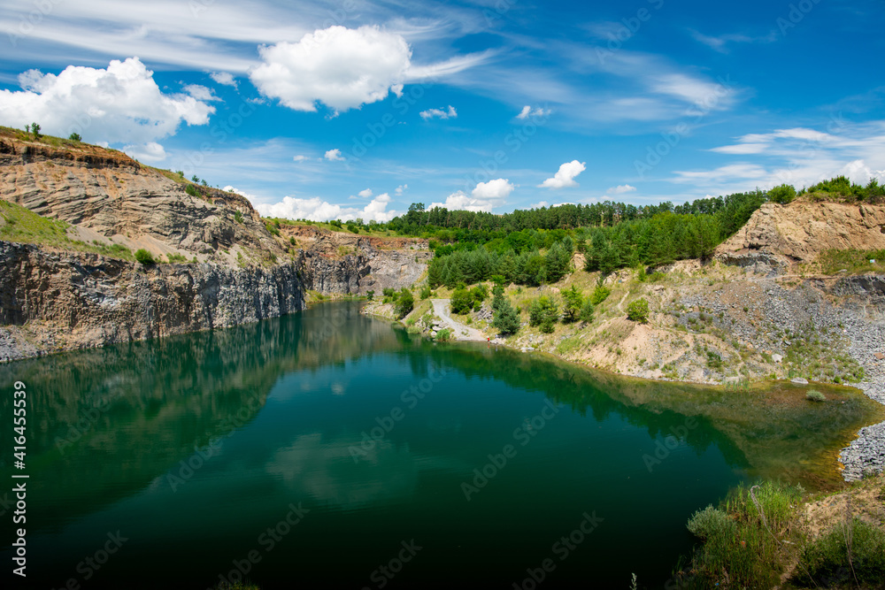 the emerald green lake between the rocks of the mountain the emerald green lake between the rocks of the mountain