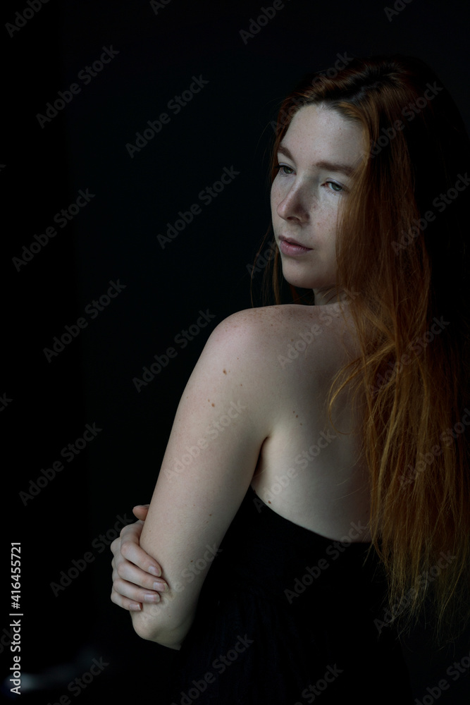 Face Close up of Ginger hair young white woman with black background Face Close up of Ginger hair young white woman with black background