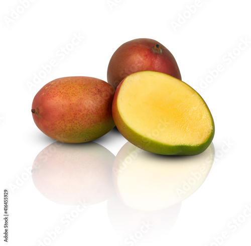 mango slice cut in half mirror shadows reflections isolated on white​ background​ with​ clipping​ path​