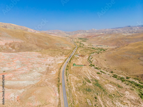 Cross-bedding in Candy Cane Mountains in Azerbaijan and road. Colorful stripes of the hills. Aerial view. © kosmos111