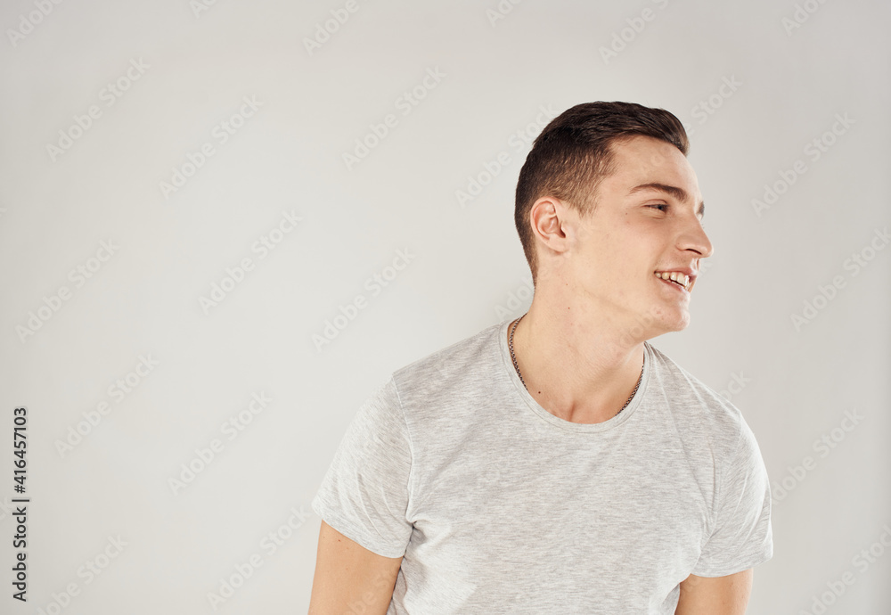 Man in white t-shirt emotions studio cropped view light background Man in white t-shirt emotions studio cropped view light background