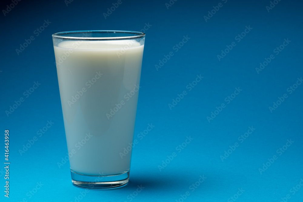 Glass of fresh milk isolated on blue background. Glass of fresh milk isolated on blue background.