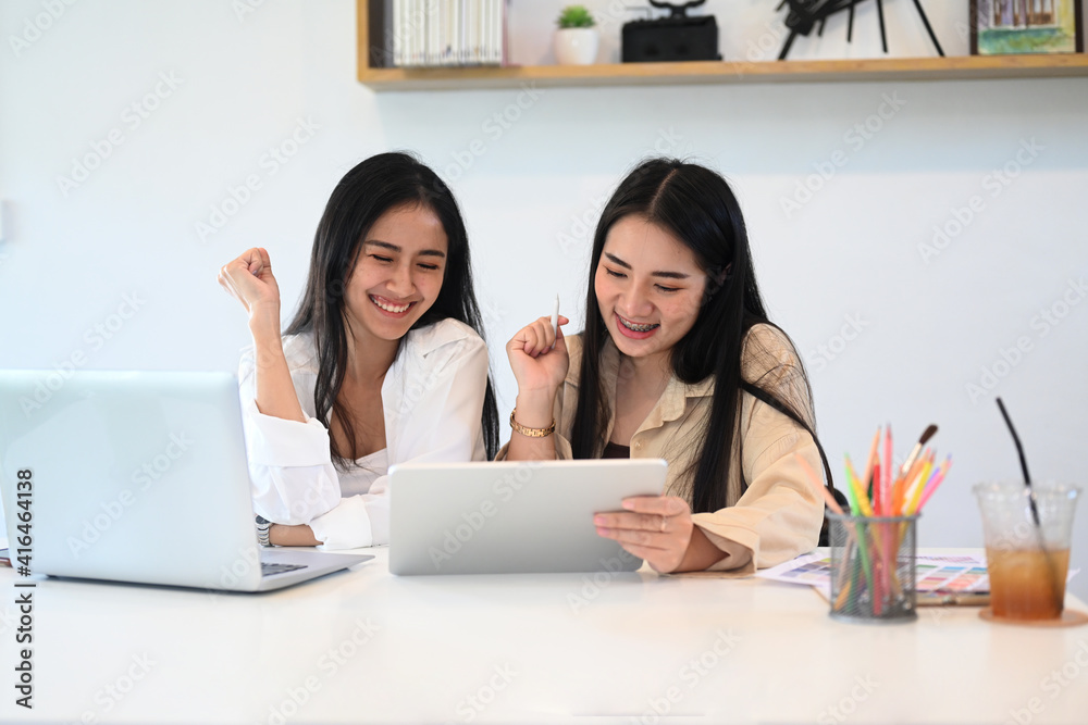 Businesswoman colleagues using digital tablet and enjoy leisure time at workplace. Businesswoman colleagues using digital tablet and enjoy leisure time at workplace.