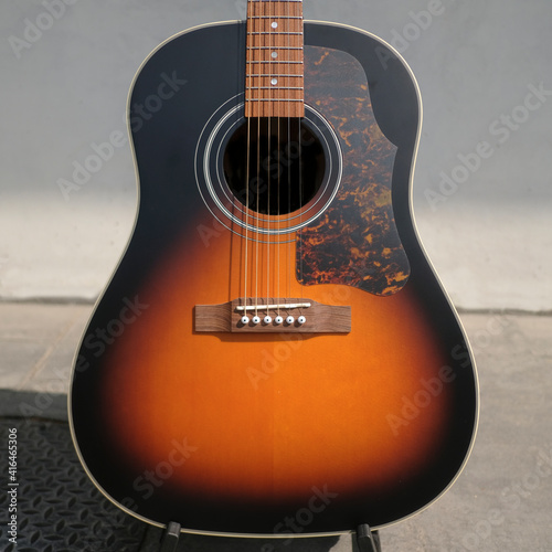 Body of Acoustic guitar with a clean background, with selective focus	 