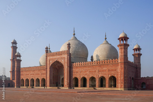 Morning view of beautiful ancient sandstone and marble landmark Badshahi mosque and courtyard built by mughal emperor Aurangzeb in Lahore, Punjab, Pakistan