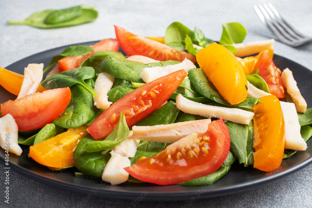 Salad of boiled squid, fresh tomatoes, spinach leaves. Delicious bright diet dish with vegetables and seafood. Salad of boiled squid, fresh tomatoes, spinach leaves. Delicious bright diet dish with vegetables and seafood.