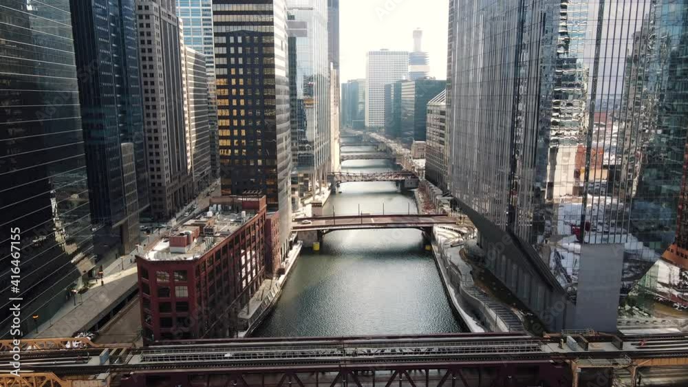 Drone Flies as Train Crosses Bridge over River in Downtown Chicago Loop