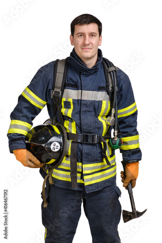 Young brave man in uniform of fireman holds axe and hardhat in his hands and looking at camera isolated on white background