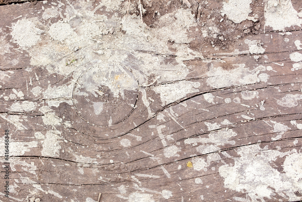 Fototapeta premium Drops and splashes from concrete on a wooden board