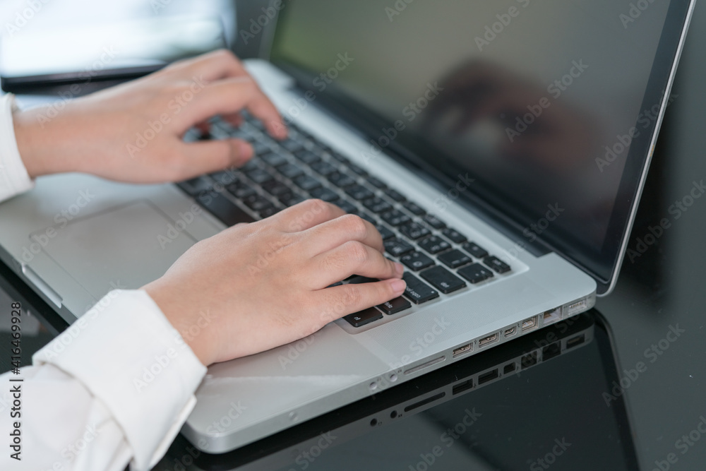 Closeup woman hand using computer laptop. Using online connect technology for business, education and communication.