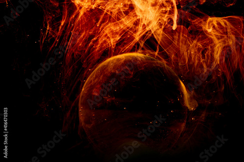 Swirling clouds of colored light around a sphere on a dark background