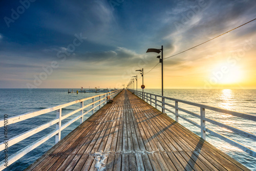 Fototapeta Naklejka Na Ścianę i Meble -  Wooden pier in Mechelinki by the Baltic Sea at sunrise, Poland.