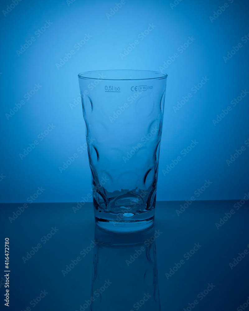 Trinkglas auf dem blauen Hintergrund