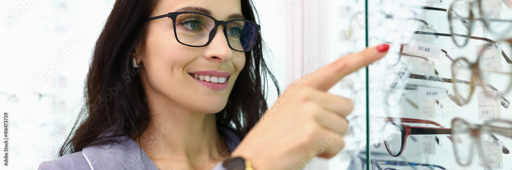 Woman consultant demonstrates showcase with optics concept Woman consultant demonstrates showcase with optics concept
