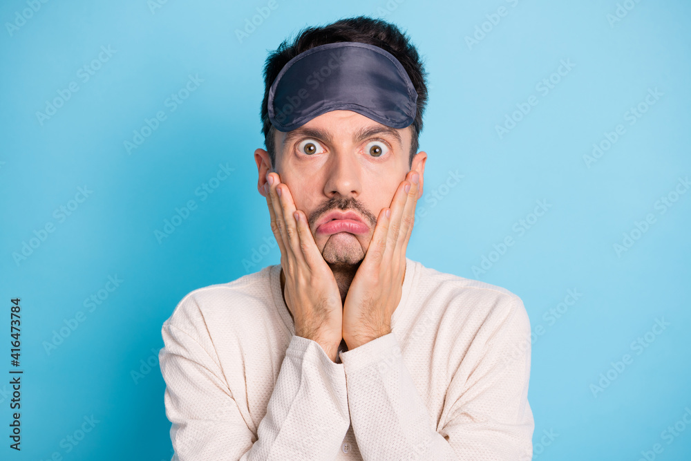 Portrait of nice worried tired bored brunet guy wearing sleep mask bad mood insomnia isolated over bright blue color background Portrait of nice worried tired bored brunet guy wearing sleep mask bad mood insomnia isolated over bright blue color background