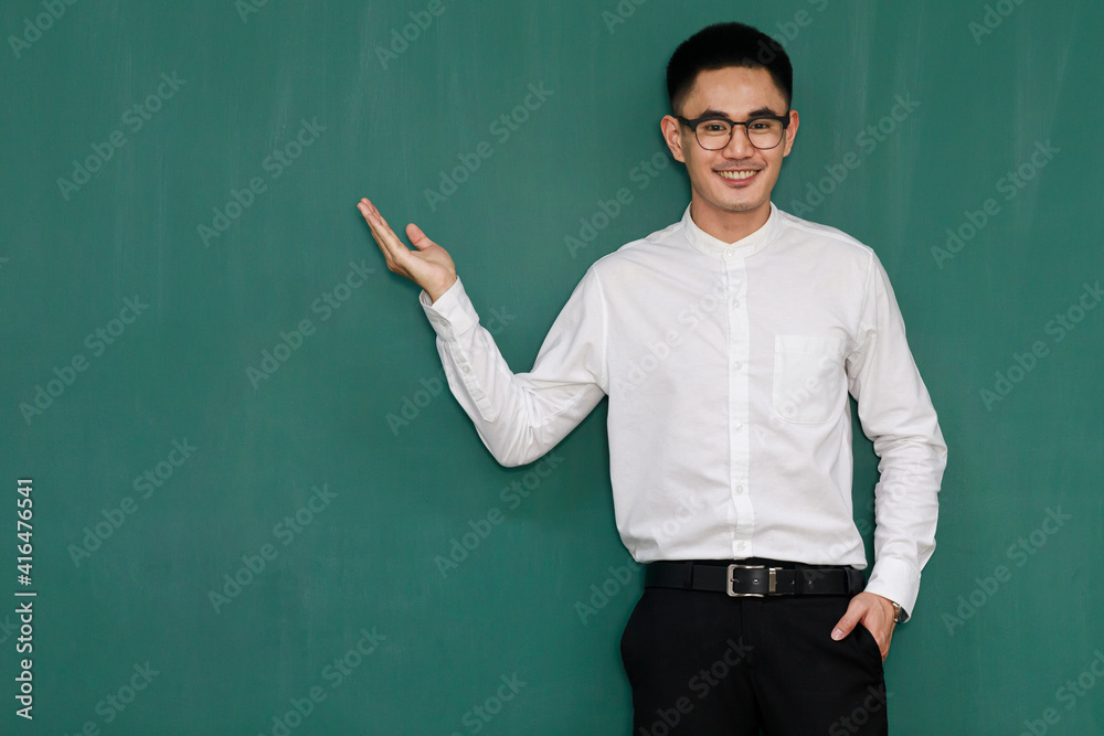 Portrait of young and handsome Asian man wearing eyeglasses and casual business clothes, white shirt and black trousers, pose in gestures of advertising and present somethings with self-confidence Portrait of young and handsome Asian man wearing eyeglasses and casual business clothes, white shirt and black trousers, pose in gestures of advertising and present somethings with self-confidence