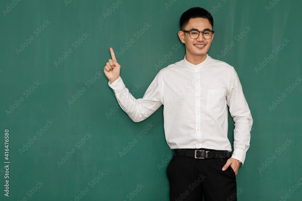 Portrait of young and handsome Asian man wearing eyeglasses and casual business clothes, white shirt and black trousers, pose in gestures of advertising and present somethings with self-confidence Portrait of young and handsome Asian man wearing eyeglasses and casual business clothes, white shirt and black trousers, pose in gestures of advertising and present somethings with self-confidence