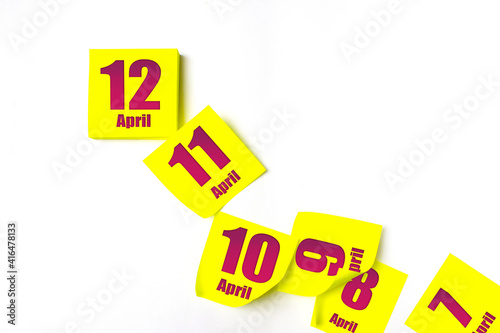 April 12nd. Day 12 of month, Calendar date. Many yellow sheet of the calendar. Spring month, day of the year concept. photo