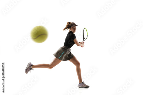 Catching. Young caucasian professional sportswoman playing tennis isolated on white background. Training, practicing in motion, action. Power and energy. Movement, ad, sport, healthy lifestyle concept