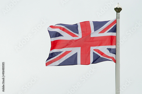 Waving british flag from the united kingdom on a white sky photo