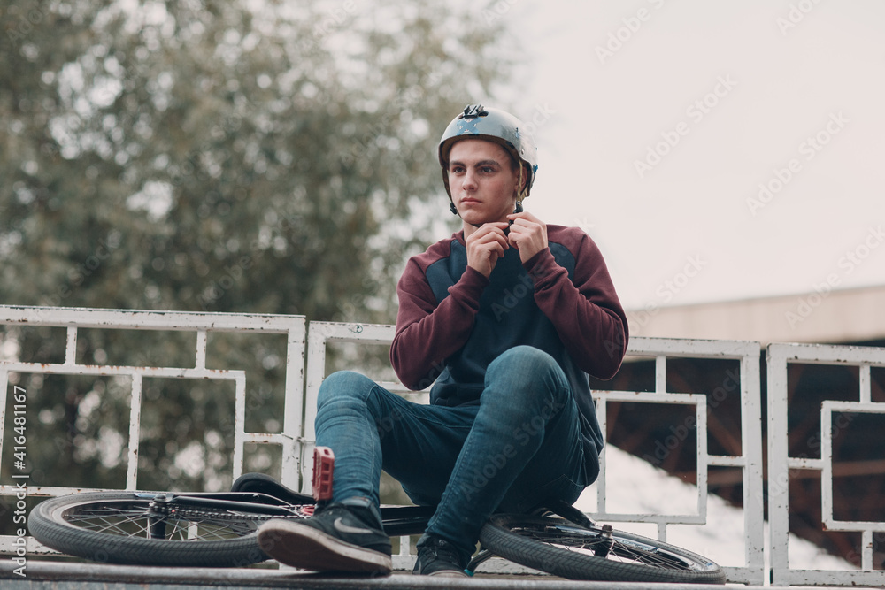 Professional young bmx sportsman cyclist with bmx bike at skatepark. Professional young bmx sportsman cyclist with bmx bike at skatepark.