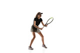 Leader. Young caucasian professional sportswoman playing tennis isolated on white background. Training, practicing in motion, action. Power and energy. Movement, ad, sport, healthy lifestyle concept.
