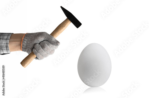 hand hold hammer and batter white chicken egg photo