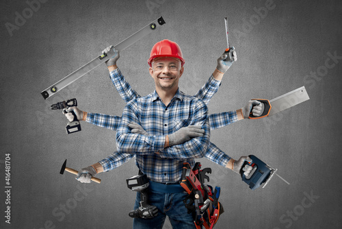 happy worker handyman ( Jack of all trades ) or builder with construction tools photo