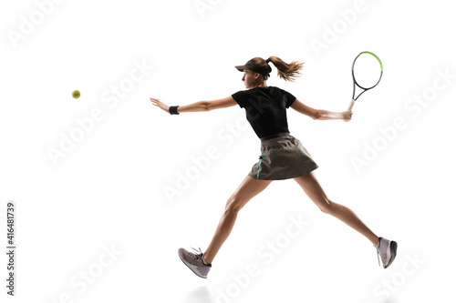 Competitive. Young caucasian professional sportswoman playing tennis on white background. Training, practicing in motion, action. Power and energy. Movement, ad, sport, healthy lifestyle concept. © master1305