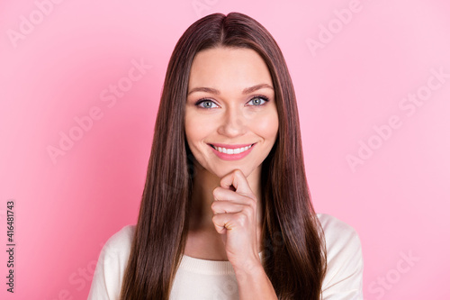 Photo of pretty satisfied lady arm finger on chin look camera toothy smile isolated on pink color background