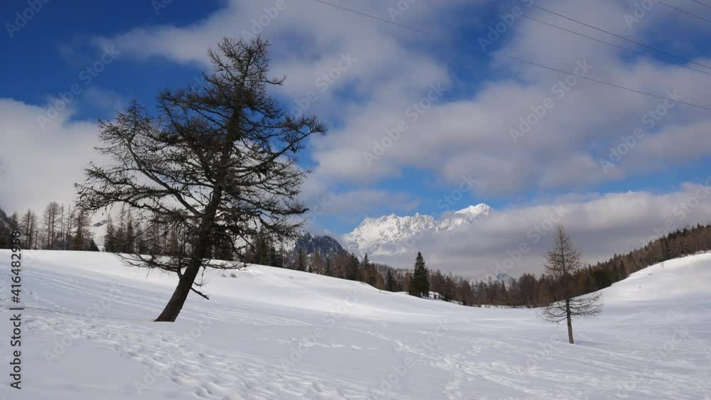 Panoramic view of a snow-covered field. Italian alps with clouds on the background. Aosta Valley, Italy Panoramic view of a snow-covered field. Italian alps with clouds on the background. Aosta Valley, Italy