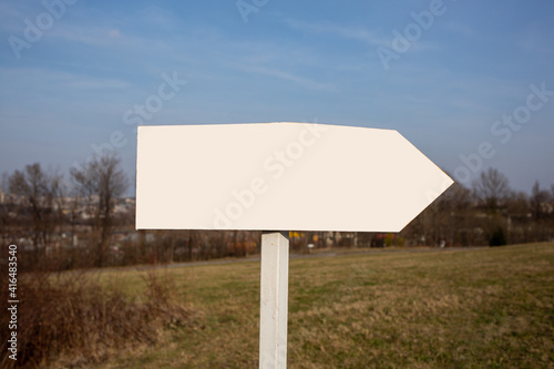 white road sign pointing in right direction