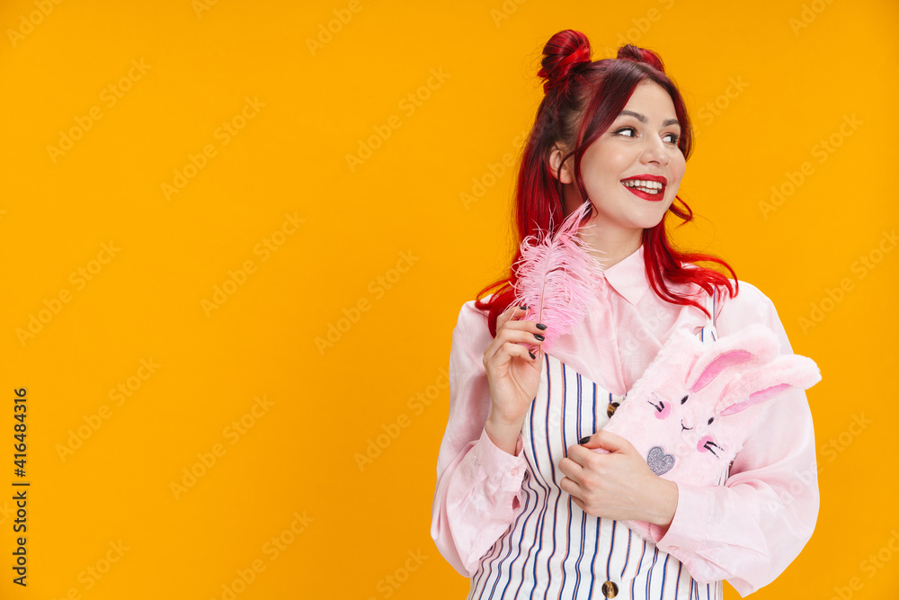 Joyful girl smiling while posing with stuffed diary and feather Joyful girl smiling while posing with stuffed diary and feather