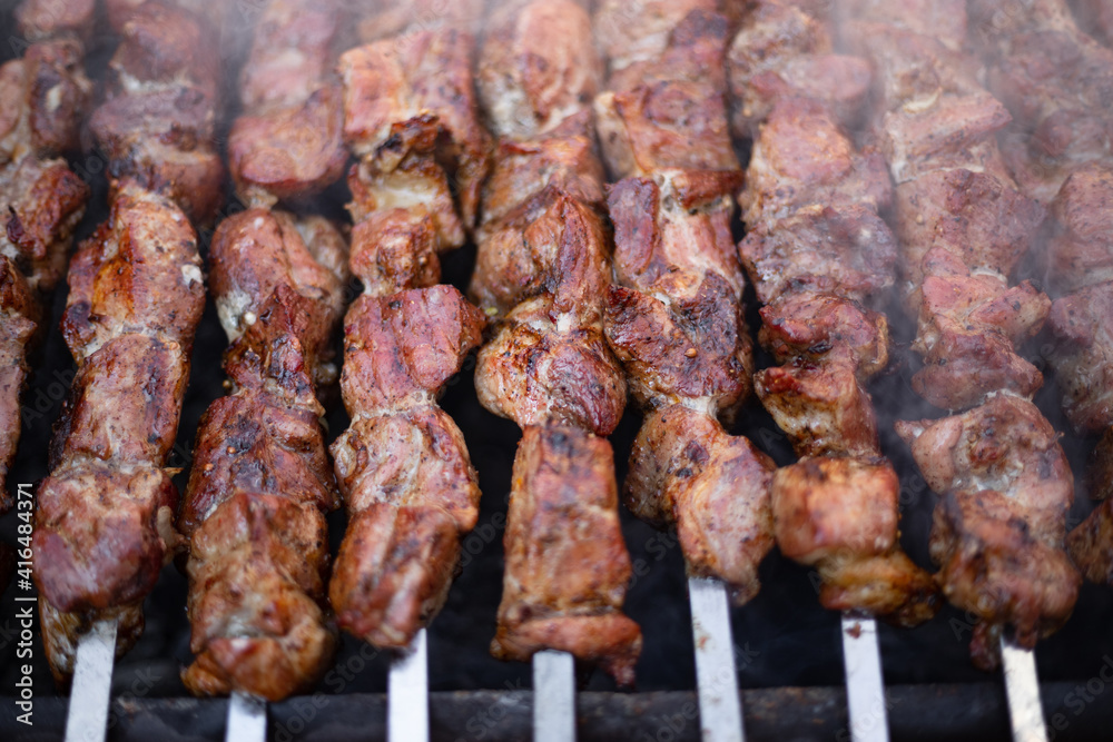Fried kebab on a homemade grill, with smoke, with a shallow depth of field