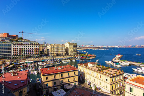 Top view of of the port, colorful buildings, embankment and gulf of Naples from the walls of the Castel dell'Ovo (Egg Castle) in Naples, Campania, Italy.