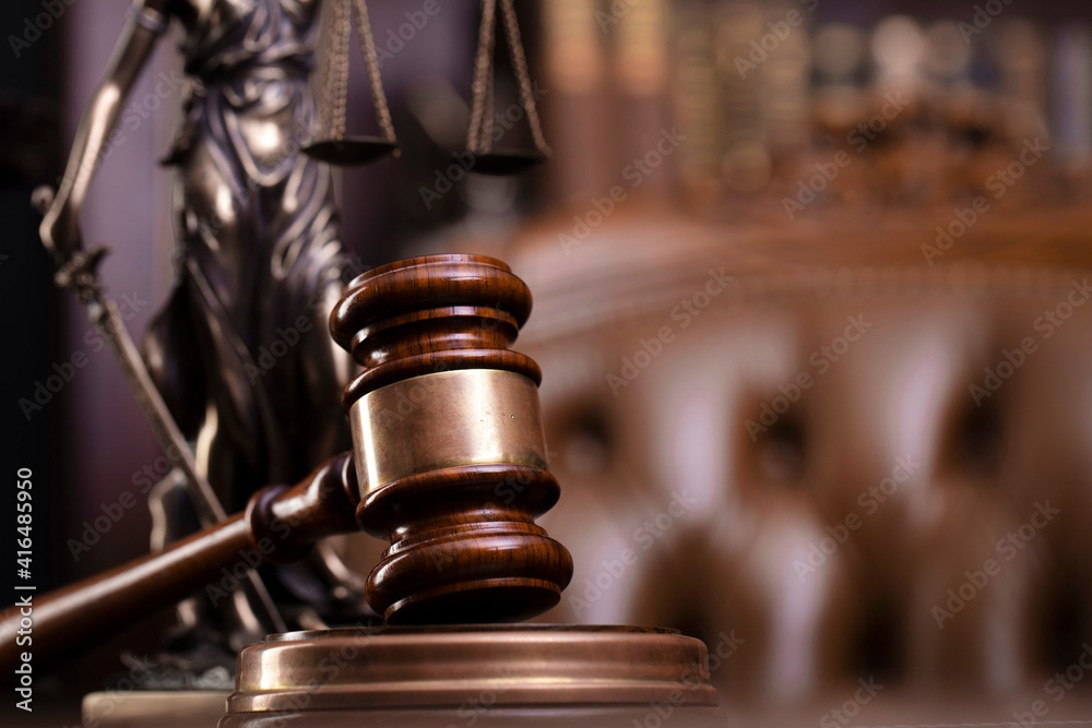 Law theme. Judge chamber. Judge’s gavel, Themis sculpture and collection of legal books on the brown background. Law theme. Judge chamber. Judge’s gavel, Themis sculpture and collection of legal books on the brown background.