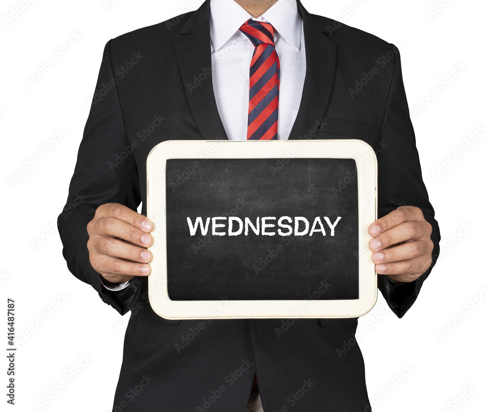A Businessman holding slate mini blackboard with Wednesday message A Businessman holding slate mini blackboard with Wednesday message