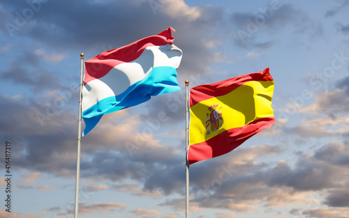Flags of Luxembourg and Spain.