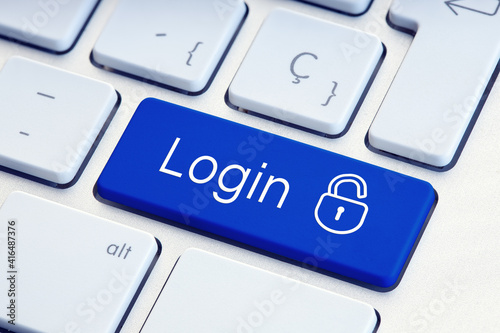 Login Word and lockpad on blue computer Keyboard Key. Technology security or hacking concept photo