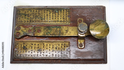 A brass telegram used for communications during second world war using Morse code encryption. Cryptography and message services.