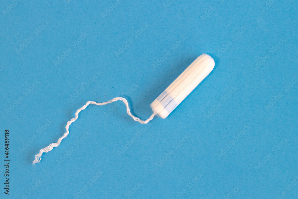 Feminine hygiene product, tampon concept on light blue background Feminine hygiene product, tampon concept on light blue background