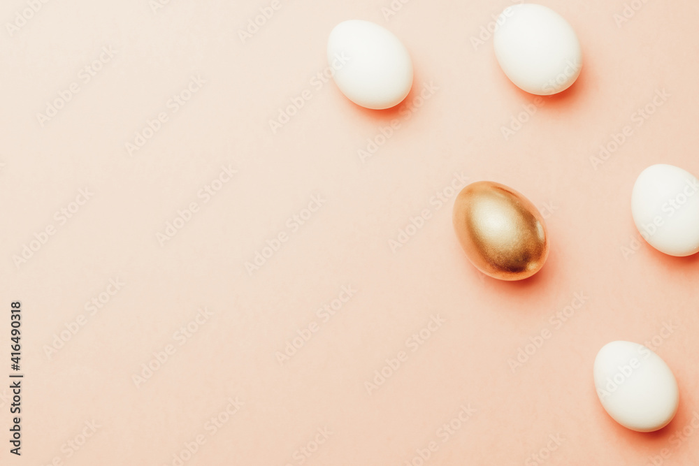 Easter card. Golden, white colour egg on pastel pink background in Happy Easter decoration. Flat lay, top view with copy space.