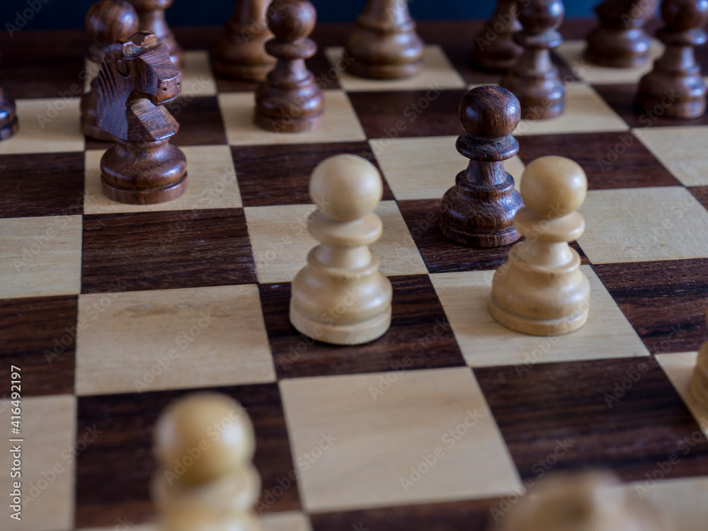 Scottish opening in chess on board and wooden pieces Scottish opening in chess on board and wooden pieces